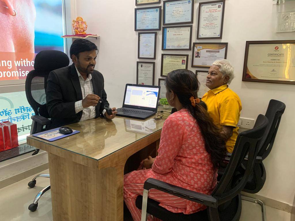 Dr. Sadanand Gore consulting with patient at his clinic, Gore Hearing and Speech Clinic